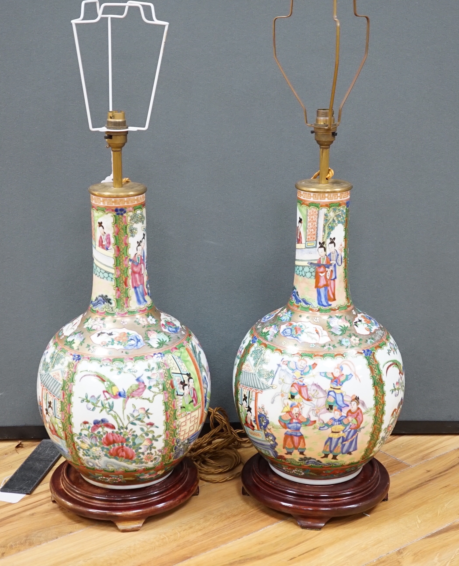 A pair of Chinese famille rose lamp bases on wooden stands, 50cm high